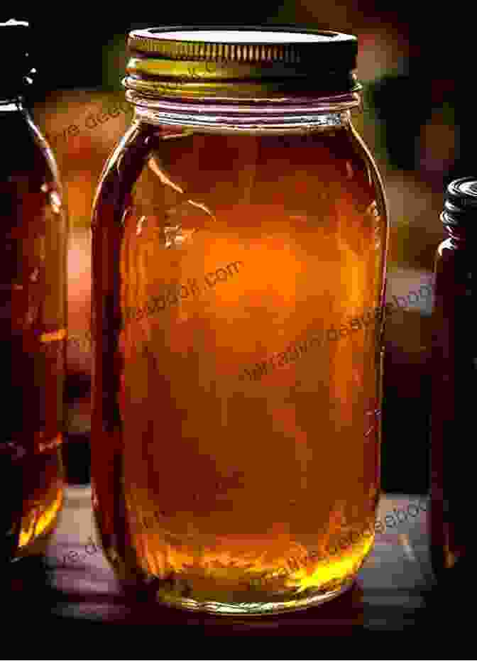 A Photograph Of A Jar Of Golden Brown Honey, Its Surface Shimmering And Viscous. Mad Honey Symposium Sally Wen Mao